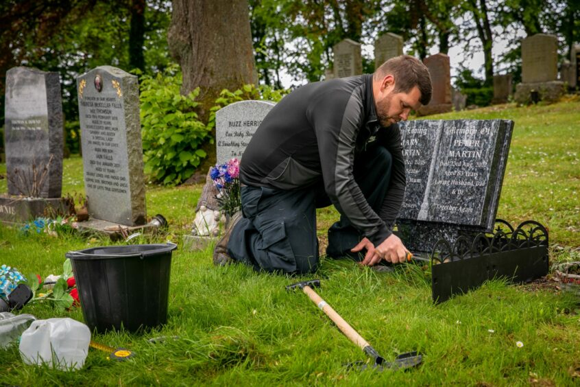 Andrew Cunningham working on a gravestone to make it a beautiful, serene place. Image: Steve Brown/DC Thomson.