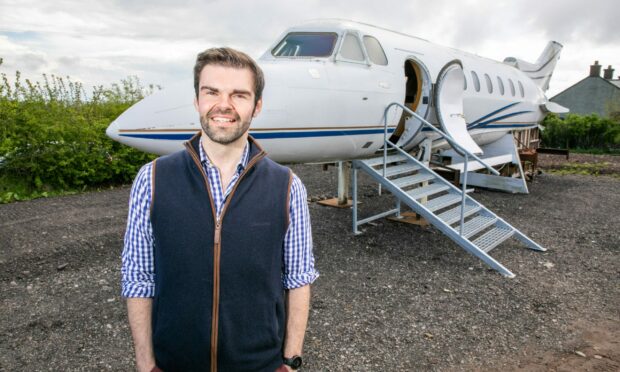 Farmer Iain Gall with the jet set to become a luxury getaway pod.  Image: Steve Brown/DC Thomson.