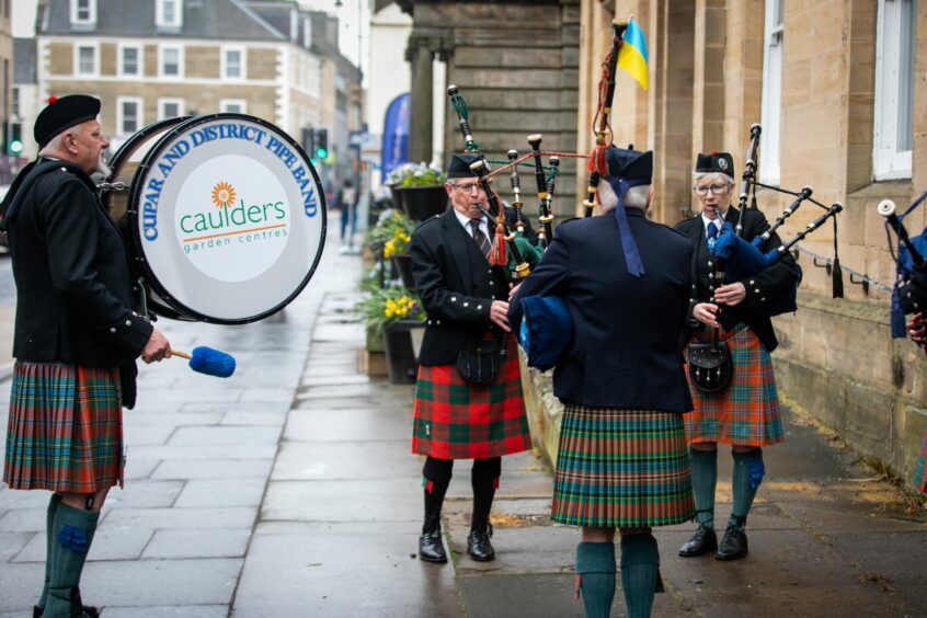  Cupar and District Pipe Band members play outside the church.. 