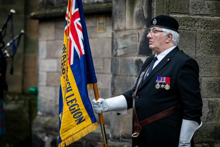 Standard Bearer Jon Coombes outside St James Episcopal Church in Cupar before the ceremony. 