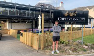 Scott Findlay, arms folded outside Cherrybank Inn