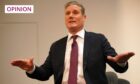 Keir Starmer with both hands outstretched, palms down.