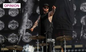 Royal Blood drummer Ben Thatcher pointing at the crowd from the stage.