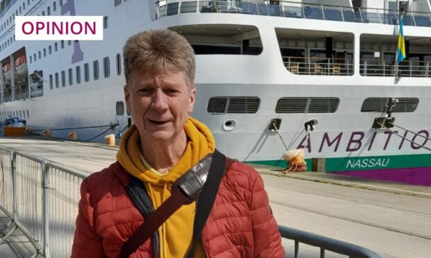 Jim Spence standing next to Ambassador cruise ship.