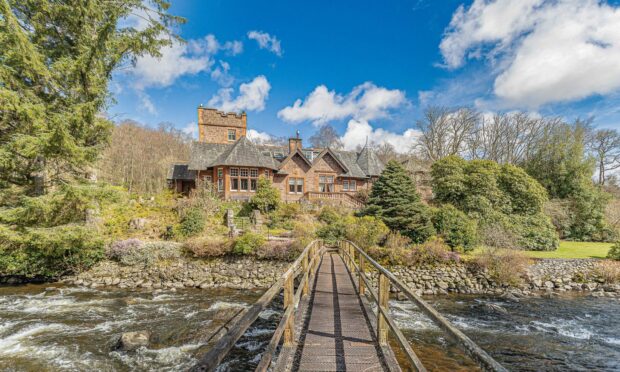 The Passhouse has a bridge to an island in the river. Image Halliday Homes.