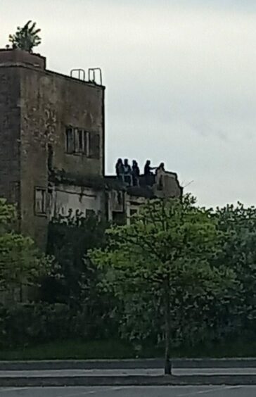 Picture shows youths on the old NCR building last week.