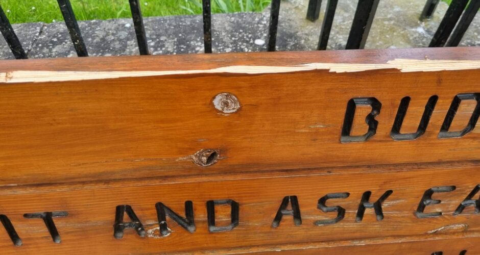 Damage along the top of one of the community benches. 