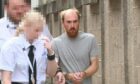 Rhys Bennett leaves Aberdeen Sheriff Court following his first appearance, three days after Jill Barclay's murder. Image: DC Thomson