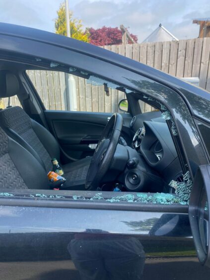Image shows the driver side window of Kerry's car smashed.