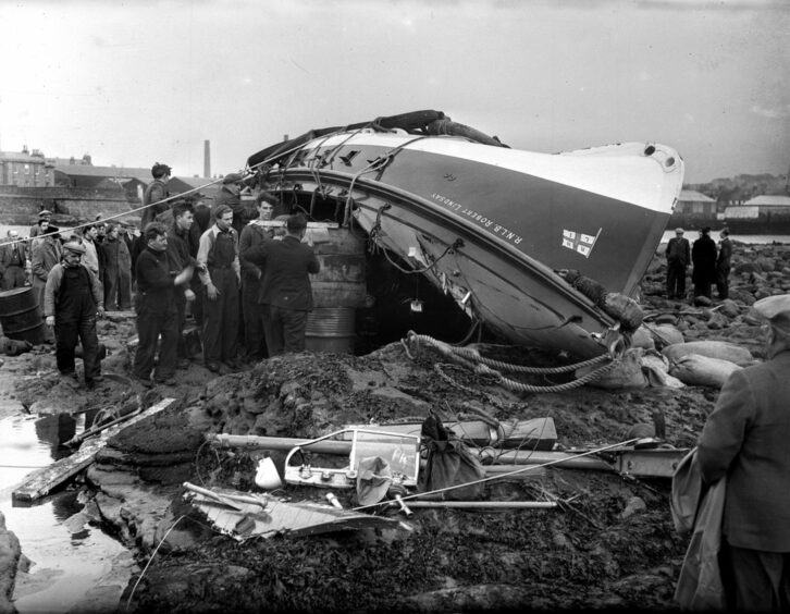 Robert Lindsay Arbroath lifeboat disaster. The upturned boat on the shoreline.