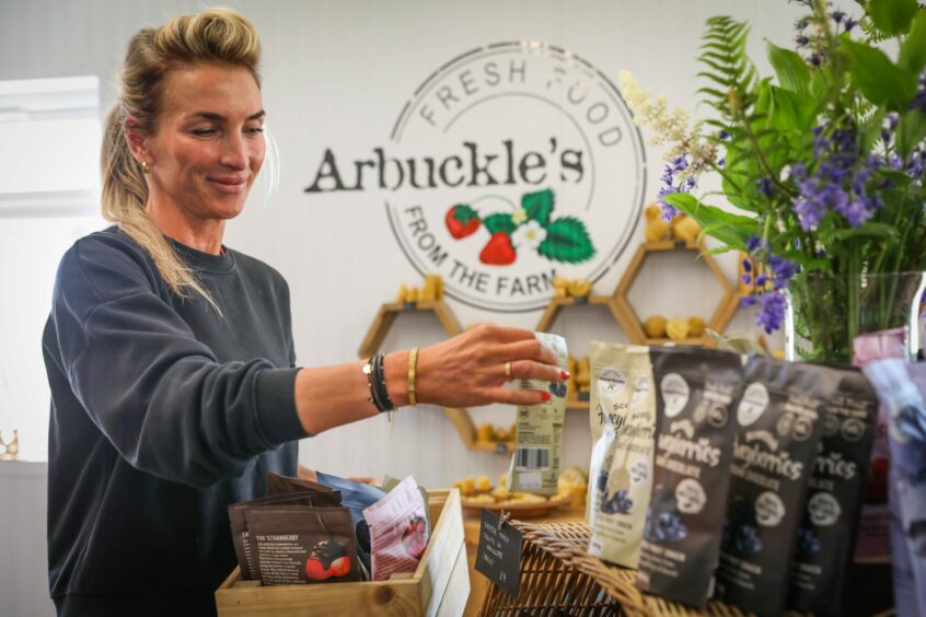 Shop manager Justyna Lupina stocking shelves in Arbuckle's Farm Shop.