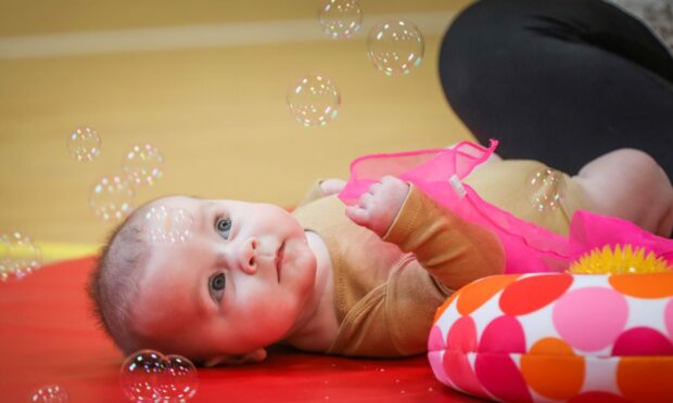 Baby watching bubbles at baby reflexology class.