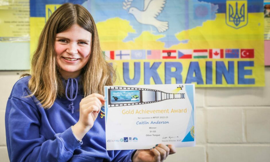 Monifieth High pupil Caitlin with her poetry prize, written in Ukrainian.