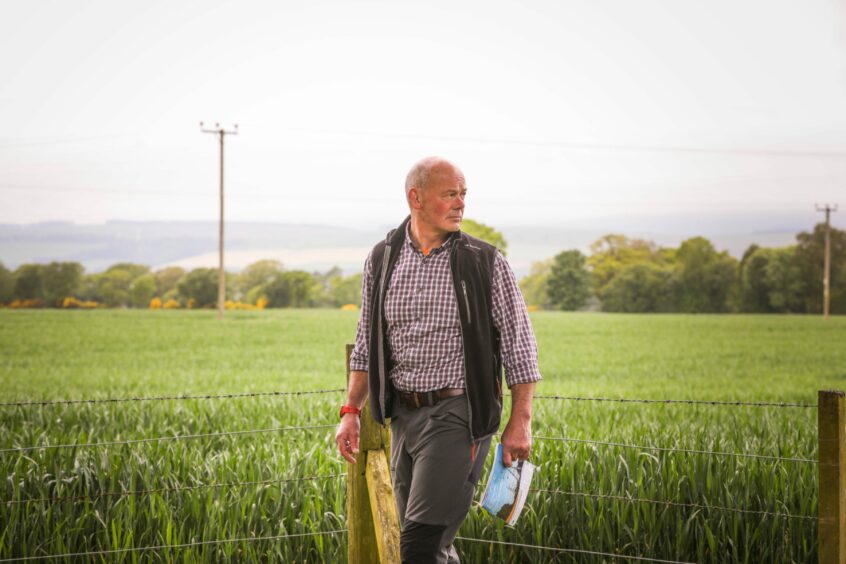 Pylons protester Ken Allison next to a field of barley in the Angus countryside.