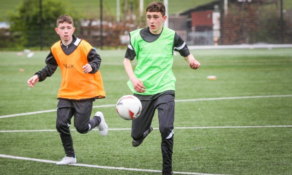 Baldragon Academy pupil Jaxon (left) on the pitch.