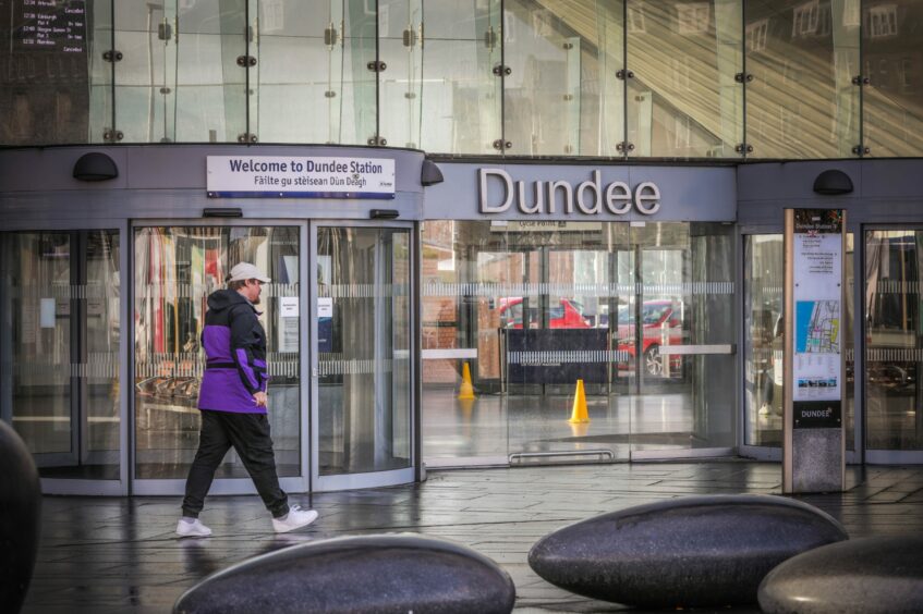 A man walking through the entrance to Dundee railway station