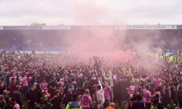 Wild celebrations among the travelling fans at Prenton Park. Image: Shutterstock