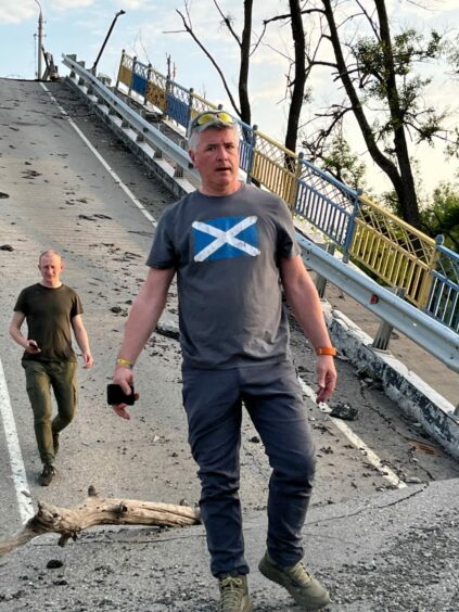 Fife aid worker David Hamilton on a destroyed bridge at Dovhen'ke. 