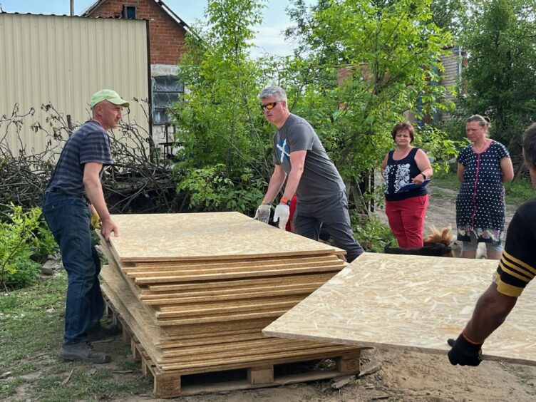 Fife aid worker David Hamilton helping to deliver roofing sheets to those in need in Ukraine. 