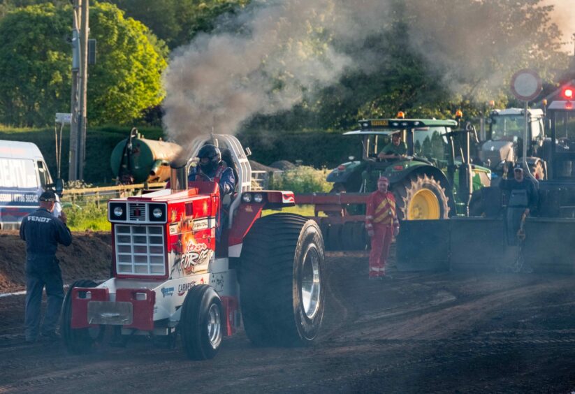 Tractor pulling at Angus show.