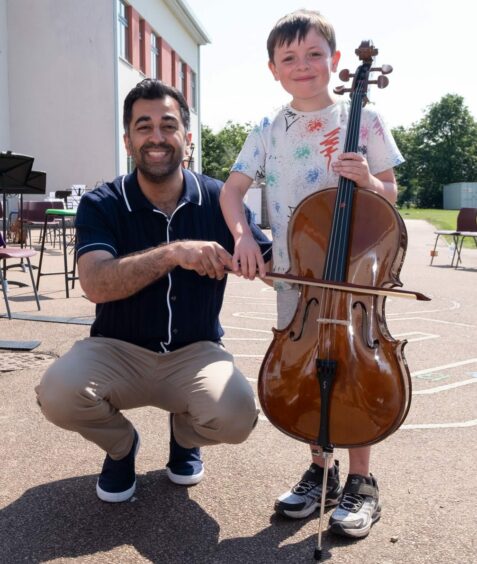 This young boy was delighted to show the First Minister his cello.