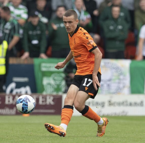 Archie Meekison plays a pass for Dundee United against Celtic. 