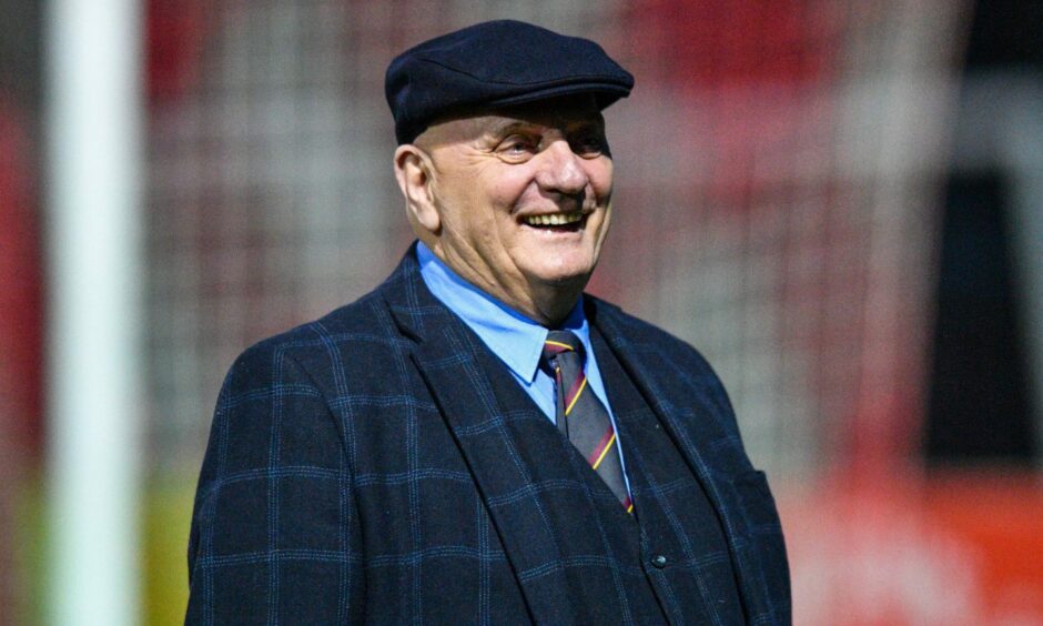 Arbroath manager Dick Campbell with a smile on his face, wearing a bunnet.