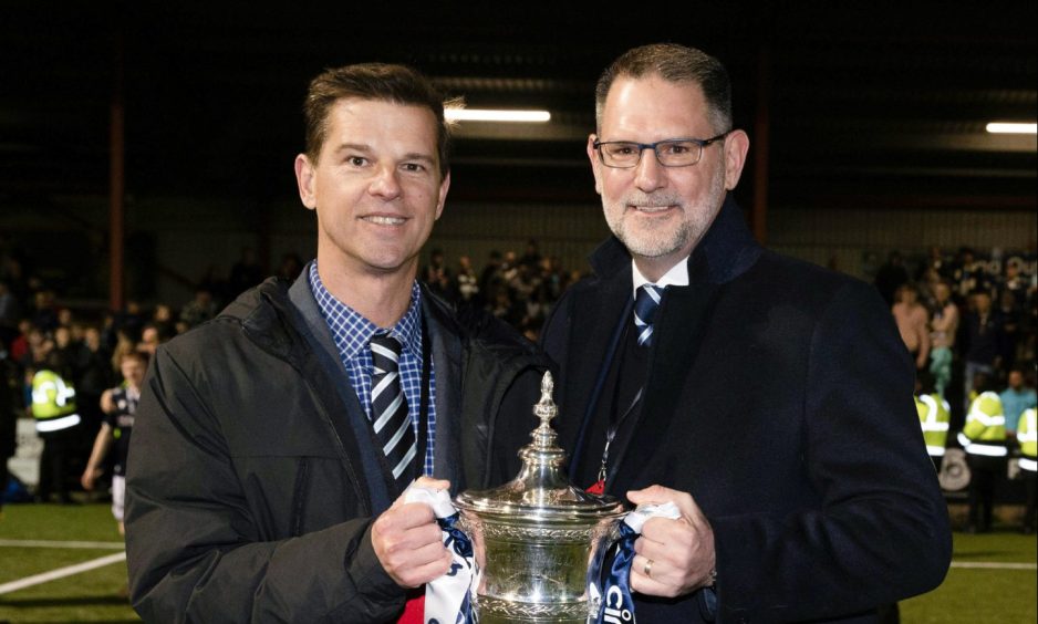 Dundee owners Tim Keyes and John Nelms celebrate with the Championship trophy. Image: SNS