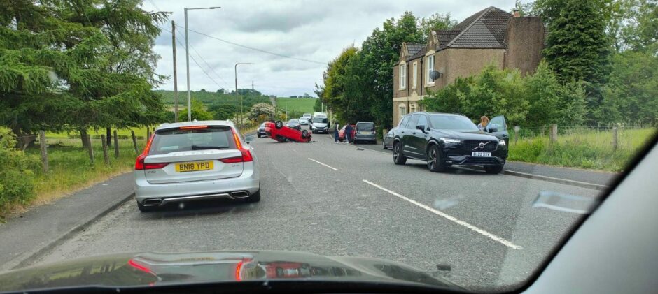 A car overturned following a two-vehicle crash in Kelty.