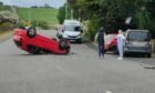 A car overturned following a two-vehicle crash in Kelty.