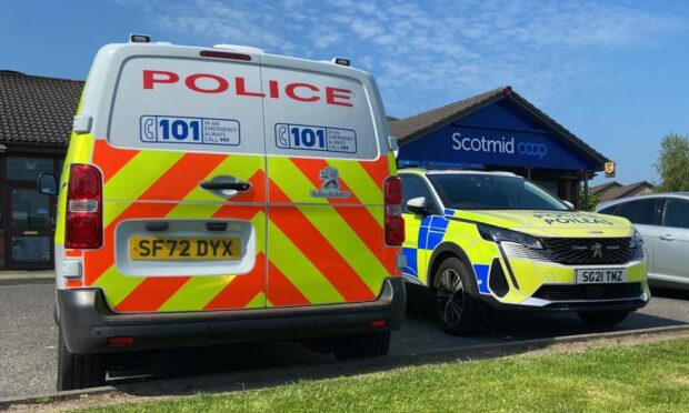 Police vehicles outside the Scotmid Co-op on West Mains Avenue, Perth