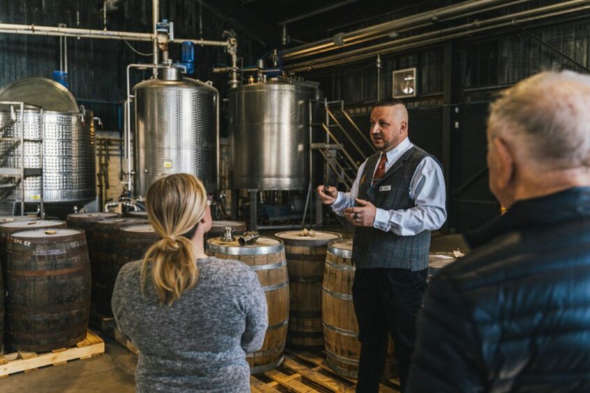 A man giving a tour at the Arbikie distillery. 