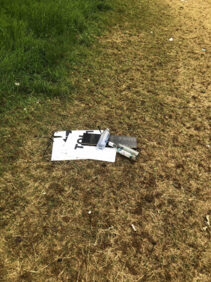 Bottles and signs left at Camperdown Park following Radio 1's Big Weekend. 