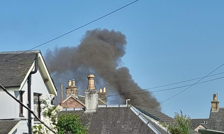 Smoke billowing into the air as seen from a distance during a fire at a Blairgowrie property