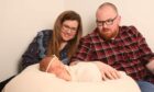 Natasha and Arron Dick with daughter Alba at her newborn shoot.