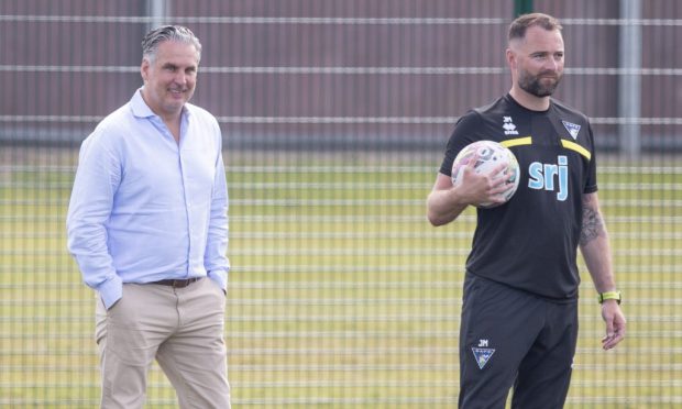 Sporting director Thomas Meggle and manager James McPake watch Dunfermline Athletic F.C. training together.