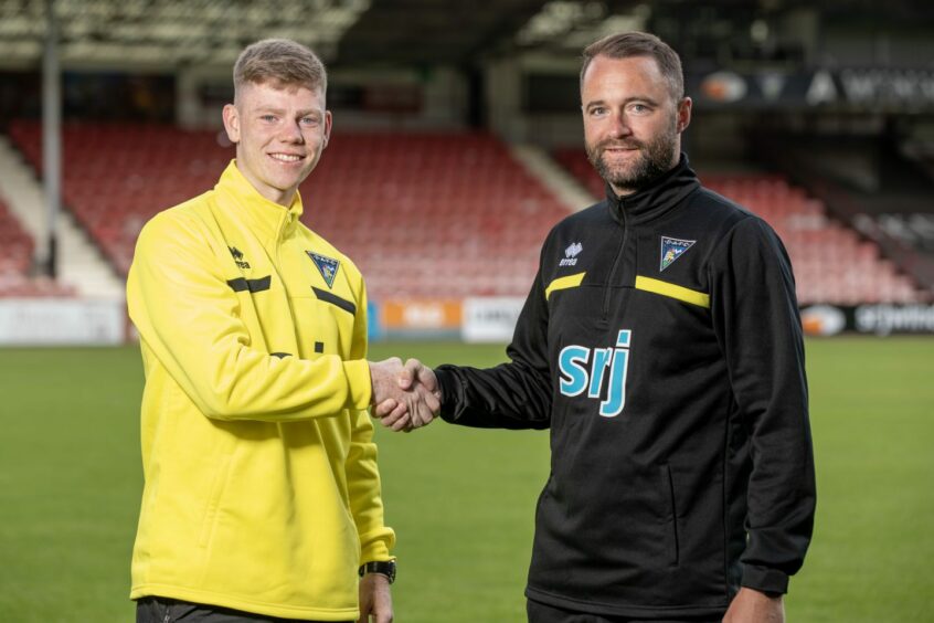 Sam Fisher and Manager James McPake shake hands for the camera at Dunfermline Athletic F.C.'s East End Park.
