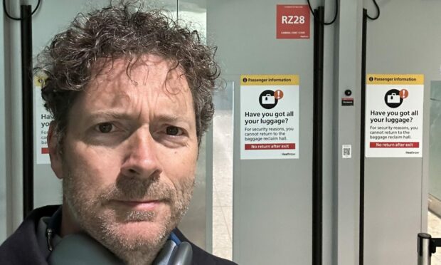 Dundee businessman Chris van der Kuyl at a locked Heathrow Airport door