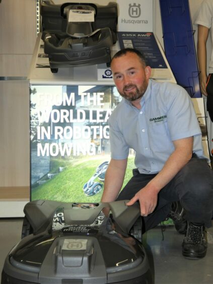 Gammies staff member with robot mower