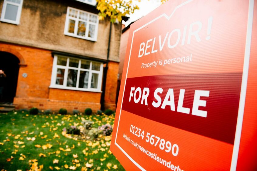 'for sale' sign outside a home's front lawn