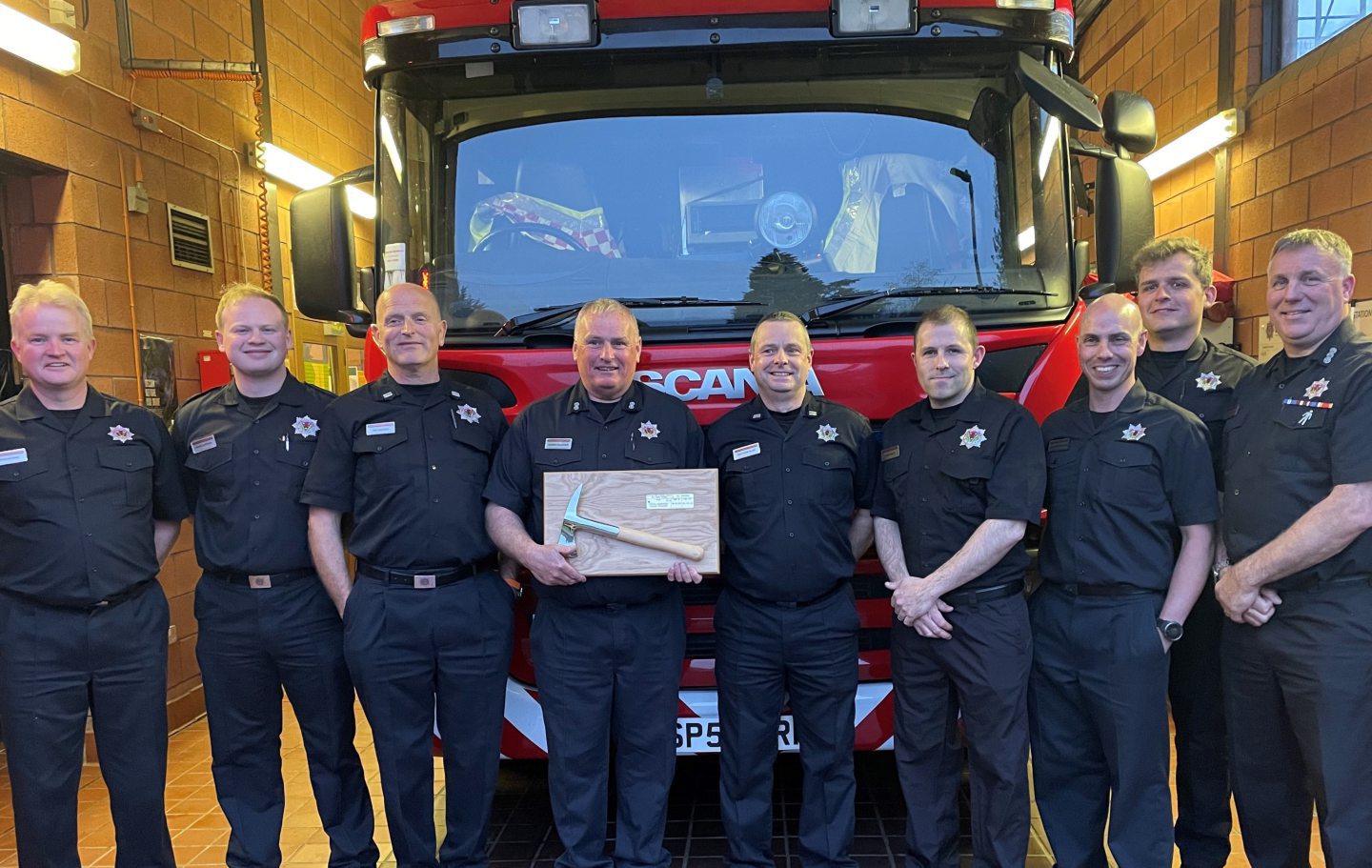 George Ferguson receives a farewell gift from colleagues at Comrie Fire Station.