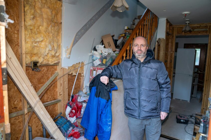 John Tomson in his damaged Freuchie Mills home after flooding in 2020. 