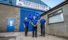 Powerwasher Services staff stands in front of sign and holds up balloons, celebrating 40 years in the business.