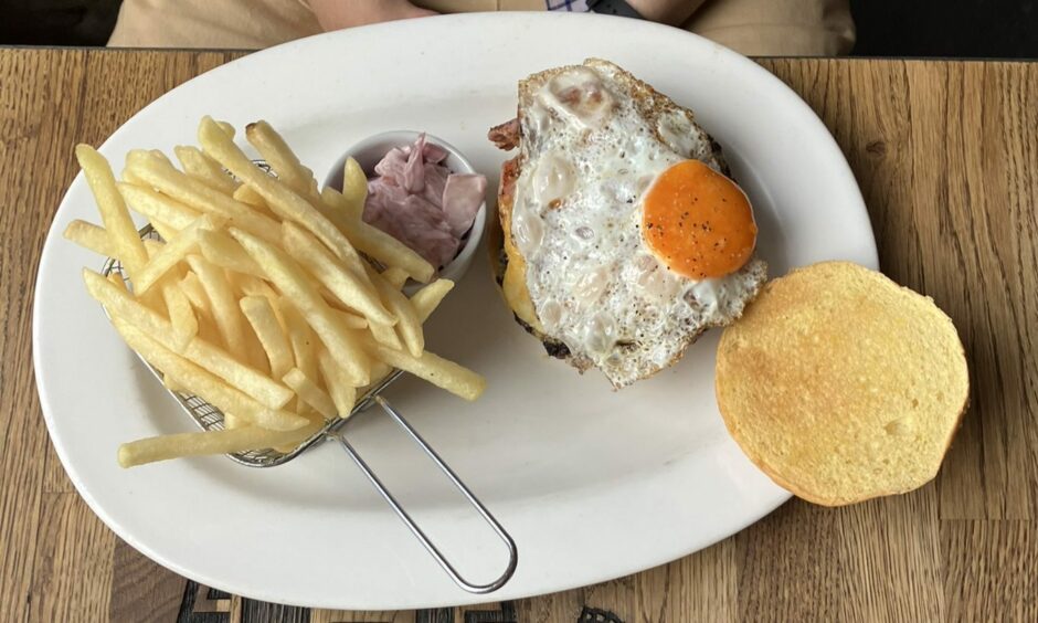 Fries, coleslaw and a burger topped with a fried egg at The Tinsmith.