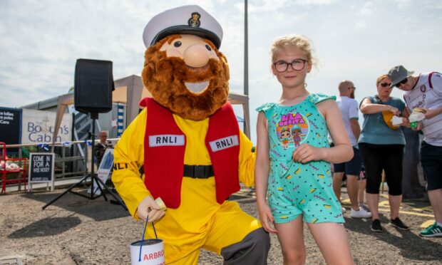 RNLI mascot Stormy Sam met Lily Duncan, 8, at the event. Image: Kim Cessford/DC Thomson.