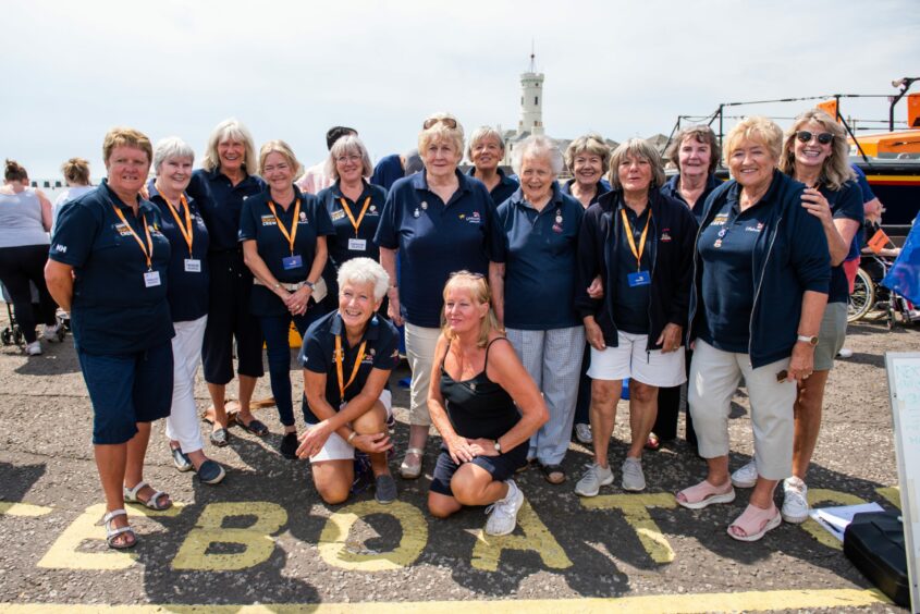 RNLI Guild president Mo Morrison (centre) is congratulated by committee members following her BEM award.