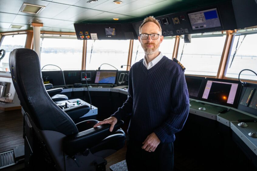 Stewart Mackay on the bridge of RRS Discovery in Dundee Harbour.