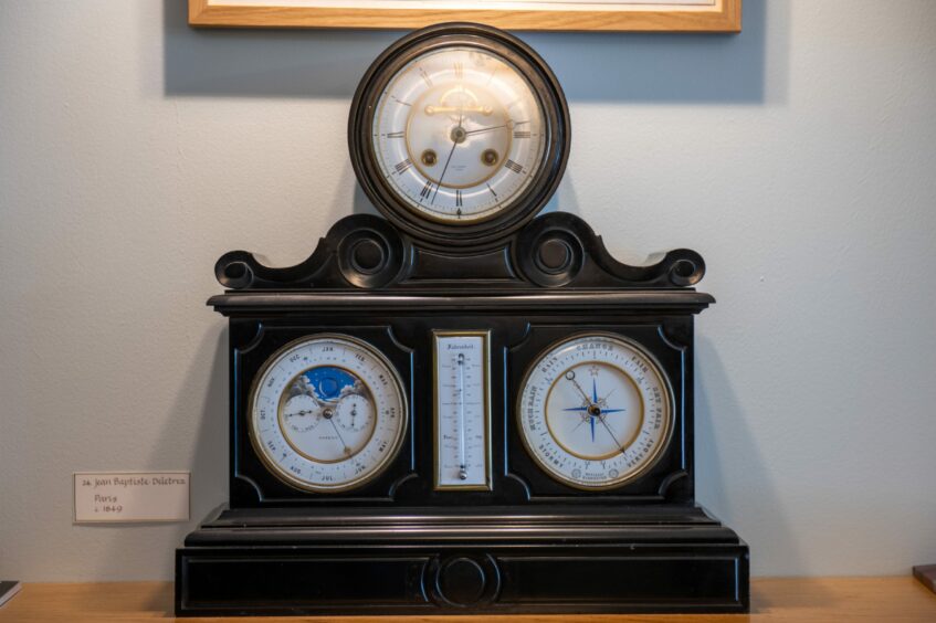 One of the clocks in the Cupar exhibition featuring a clock, calendar, thermometer and barometer