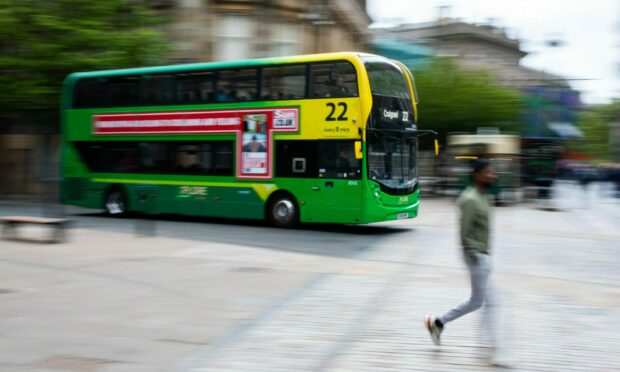 Blurred shot of an Xplore Dundee bus moving through the city centre.
