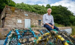 Mr Adams outside the fire-hit West Wemyss boat club.